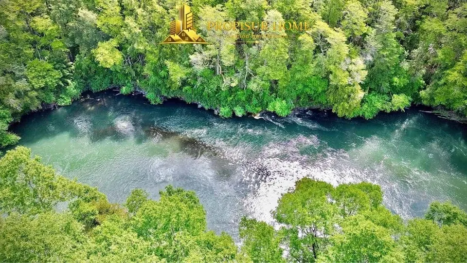 Vista aérea del río Trancura que atraviesa el complejo turístico en venta en Pucón - Propisur Home SpA.